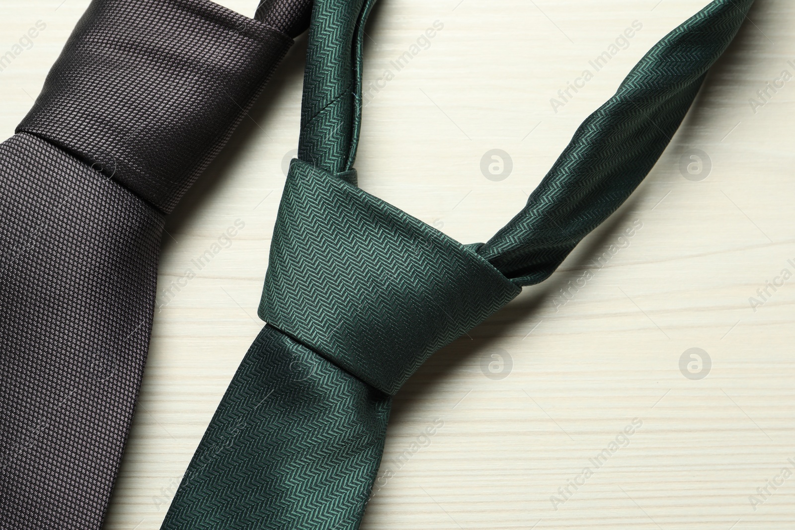 Photo of Two neckties on white wooden table, top view