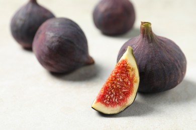 Whole and cut ripe figs on light table, closeup
