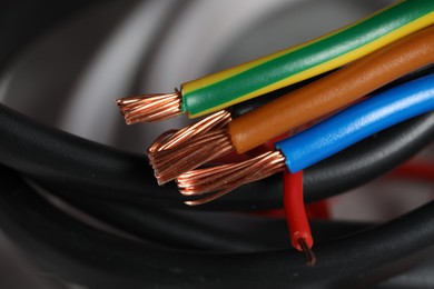 Photo of Colorful electrical wires on blurred background, closeup