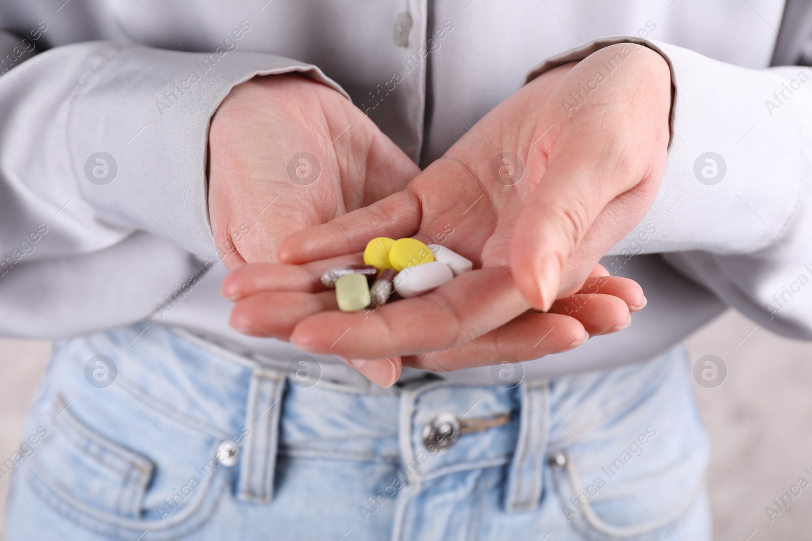 Photo of Woman holding pile of antidepressants, closeup view