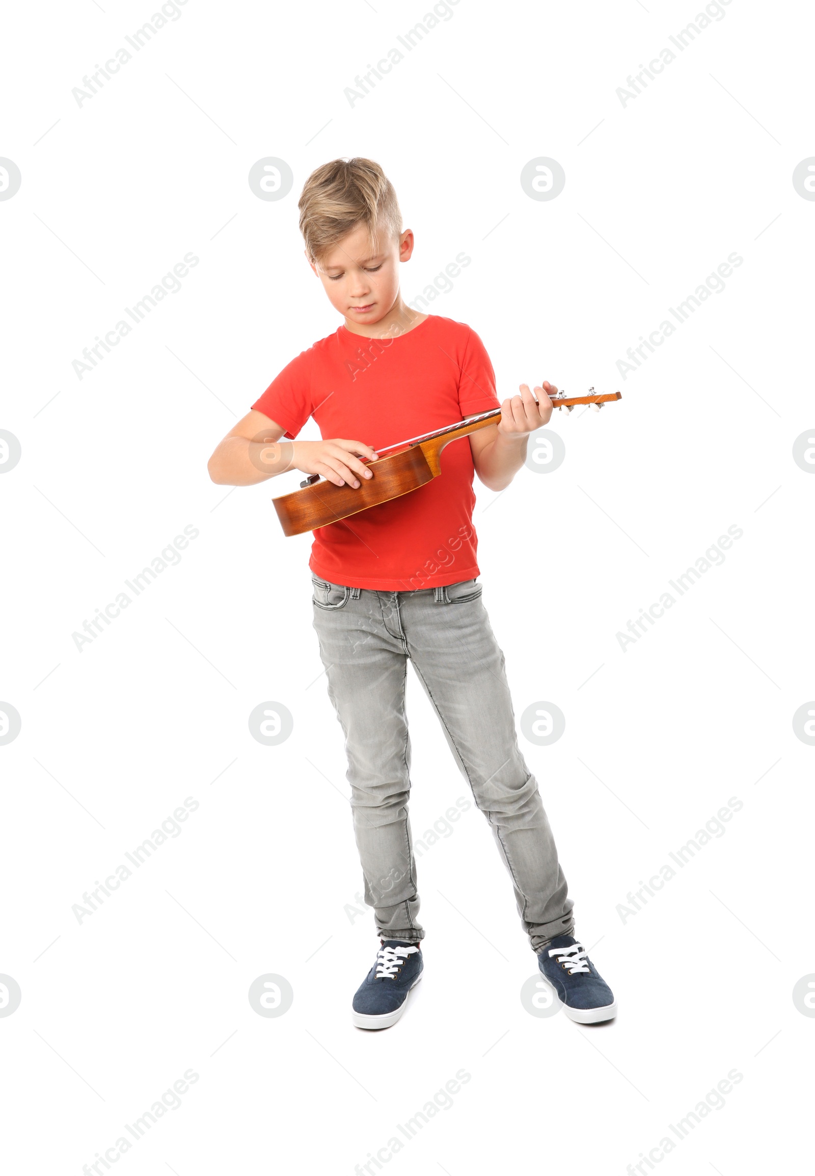 Photo of Cute little boy playing guitar isolated on white