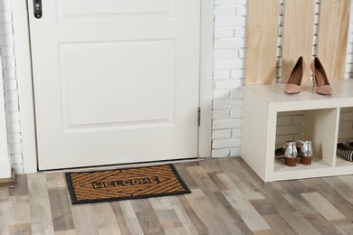 Hallway interior with shoe rack and mat near door