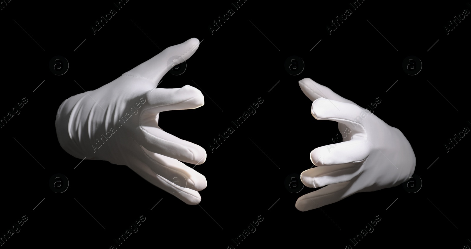 Photo of Magician holding something on black background, closeup