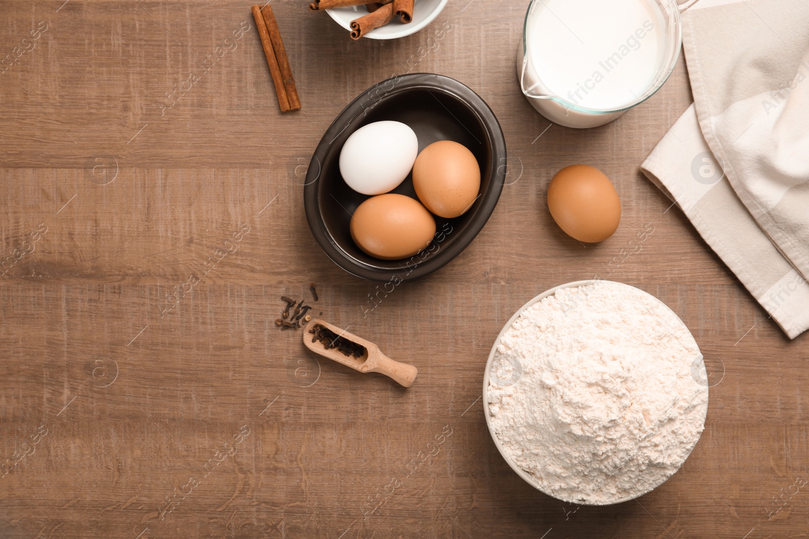 Photo of Composition with flour, eggs and spices on wooden background, top view