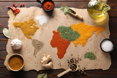 Photo of World map of different spices and products on wooden table, top view