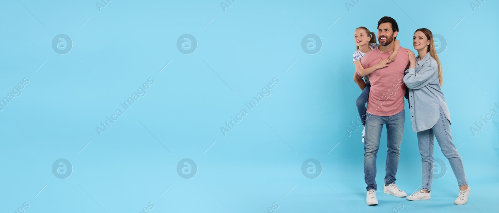 Image of Happy family with child on light blue background, space for text. Banner design