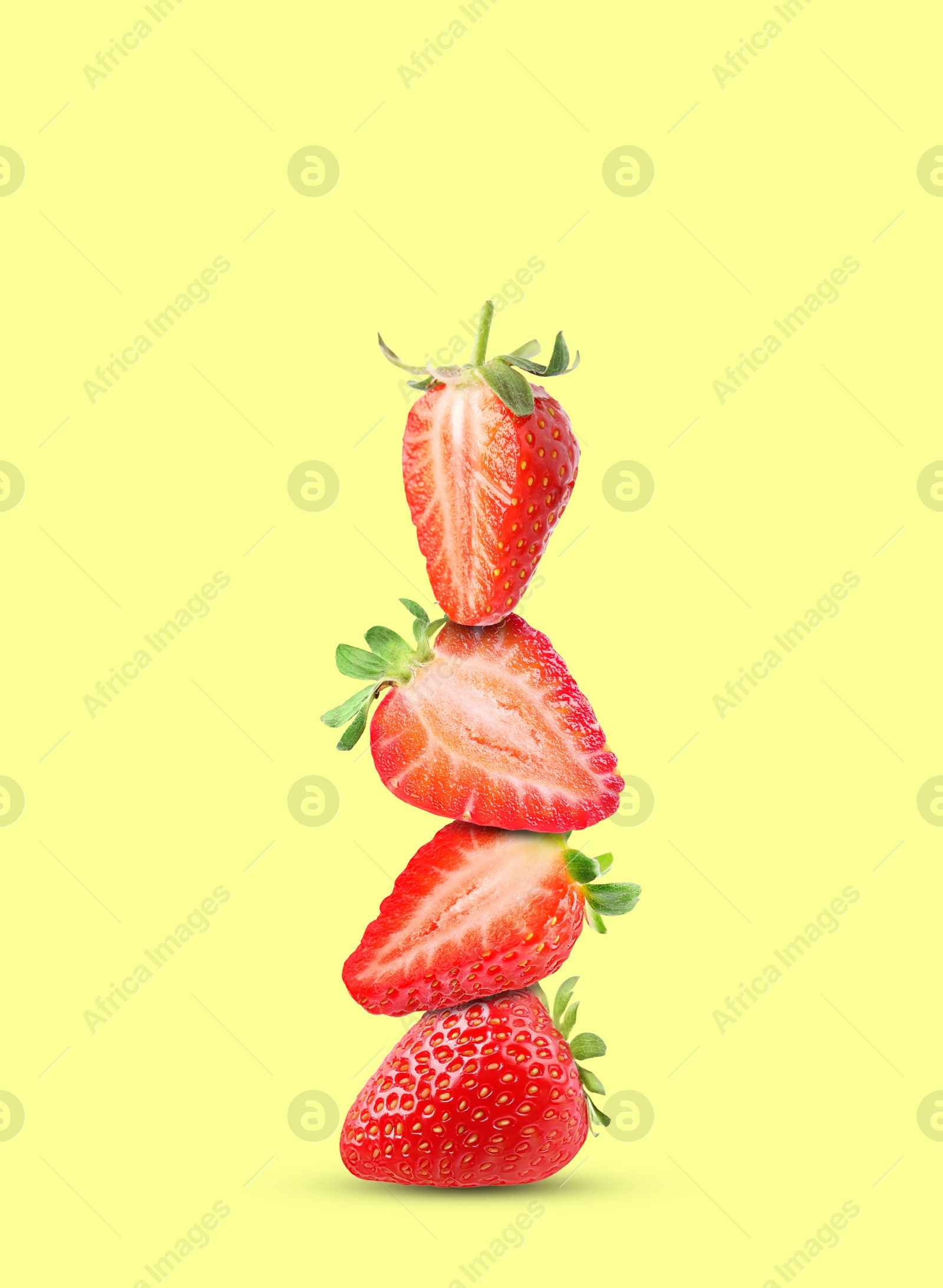 Image of Stack of fresh strawberries on light yellow background