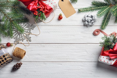 Photo of Flat lay composition with Christmas gifts and decoration on wooden background