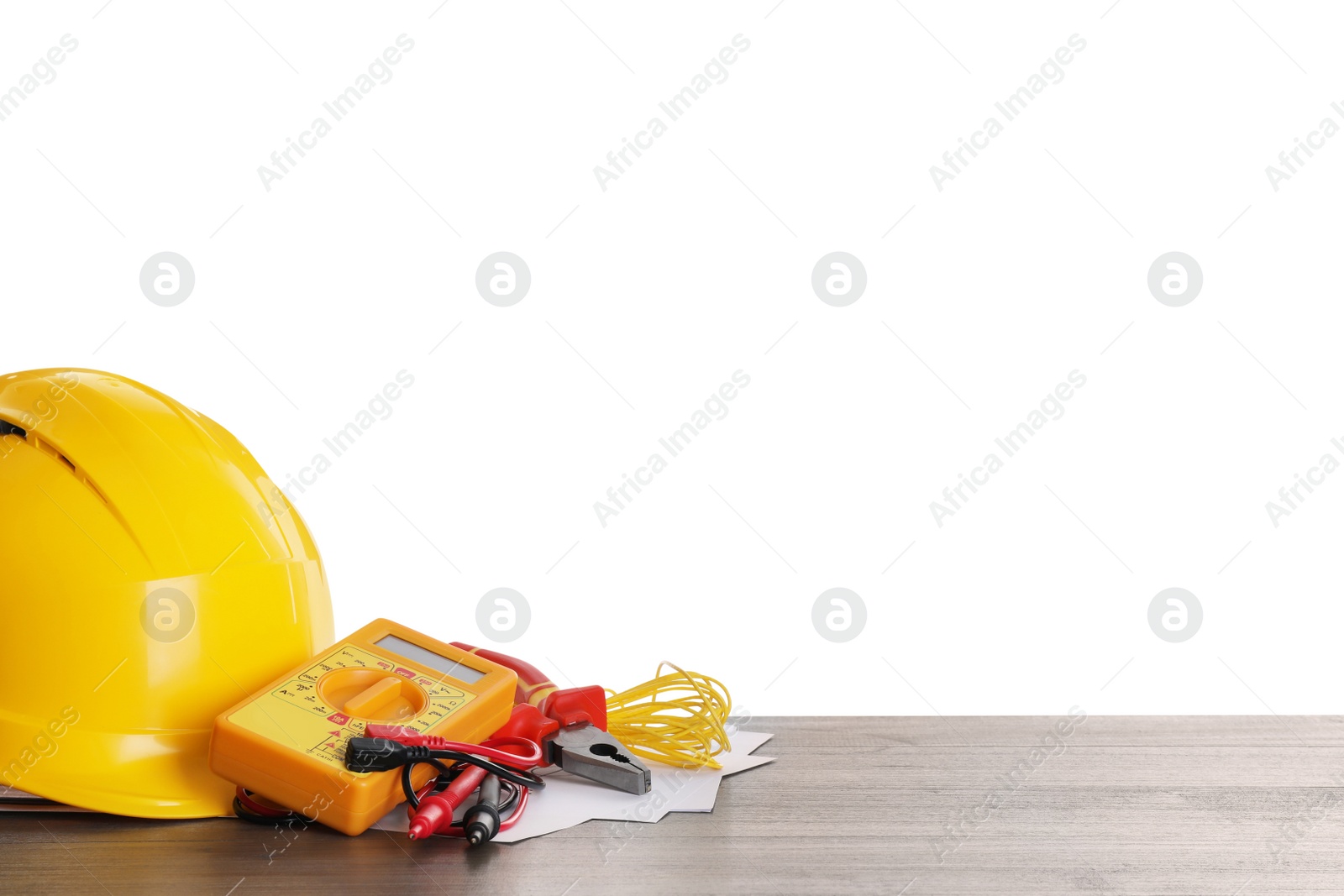 Photo of Set of electrician's tools and accessories on wooden table against white background