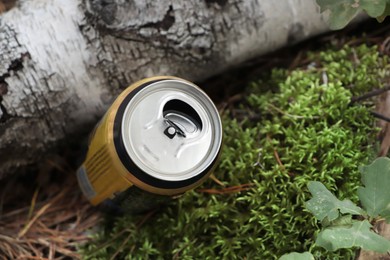 Photo of Used aluminum can on ground outdoors, closeup. Recycling problem
