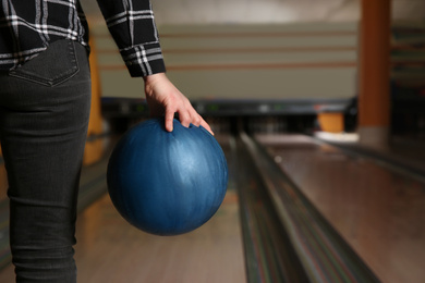 Photo of Woman with ball in bowling club, closeup. Space for text