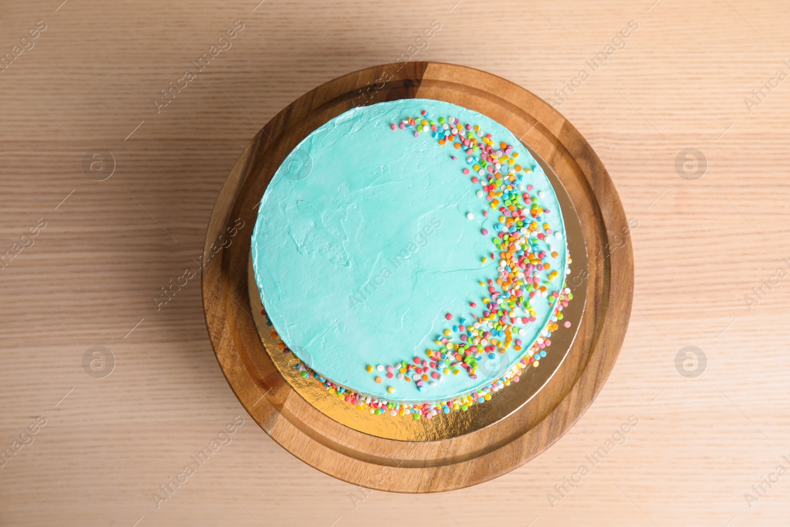 Photo of Fresh delicious birthday cake on wooden background, top view