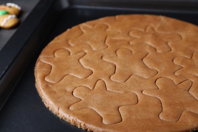 Photo of Making homemade gingerbread man cookies in baking dish, closeup