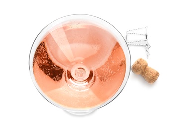 Glass of rose champagne and cork plug on white background