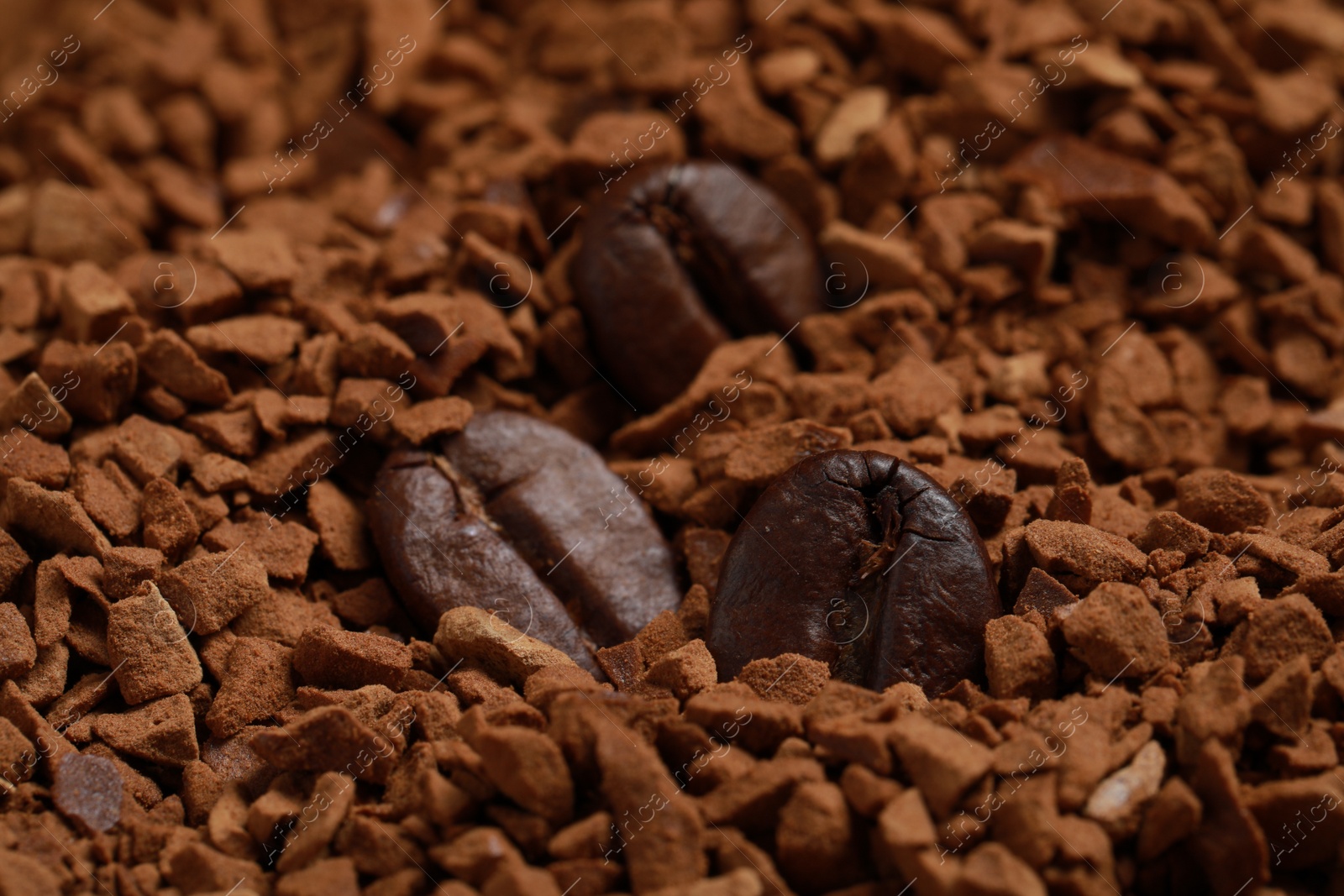 Photo of Roasted beans on instant coffee, closeup view