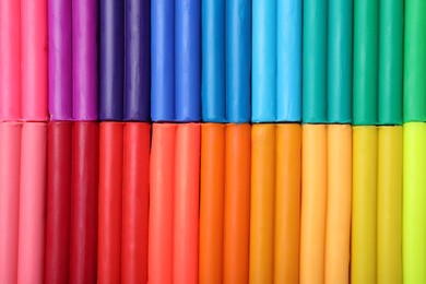 Photo of Many different colorful plasticine pieces as background, top view