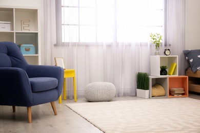 Photo of Modern child room interior with comfortable armchair