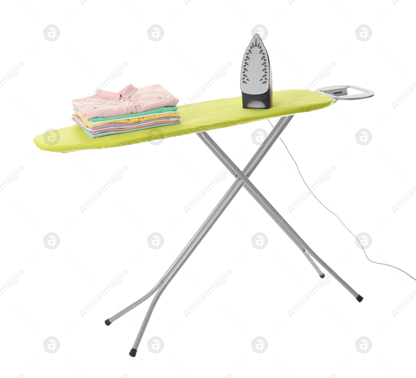 Photo of Board with modern iron and clean laundry on white background