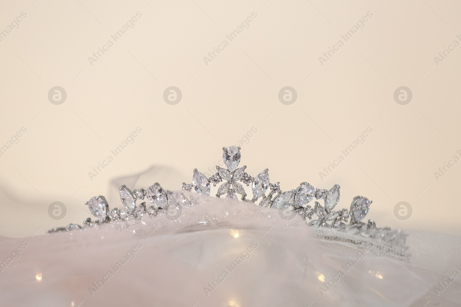 Photo of Beautiful silver tiara with diamonds on light cloth