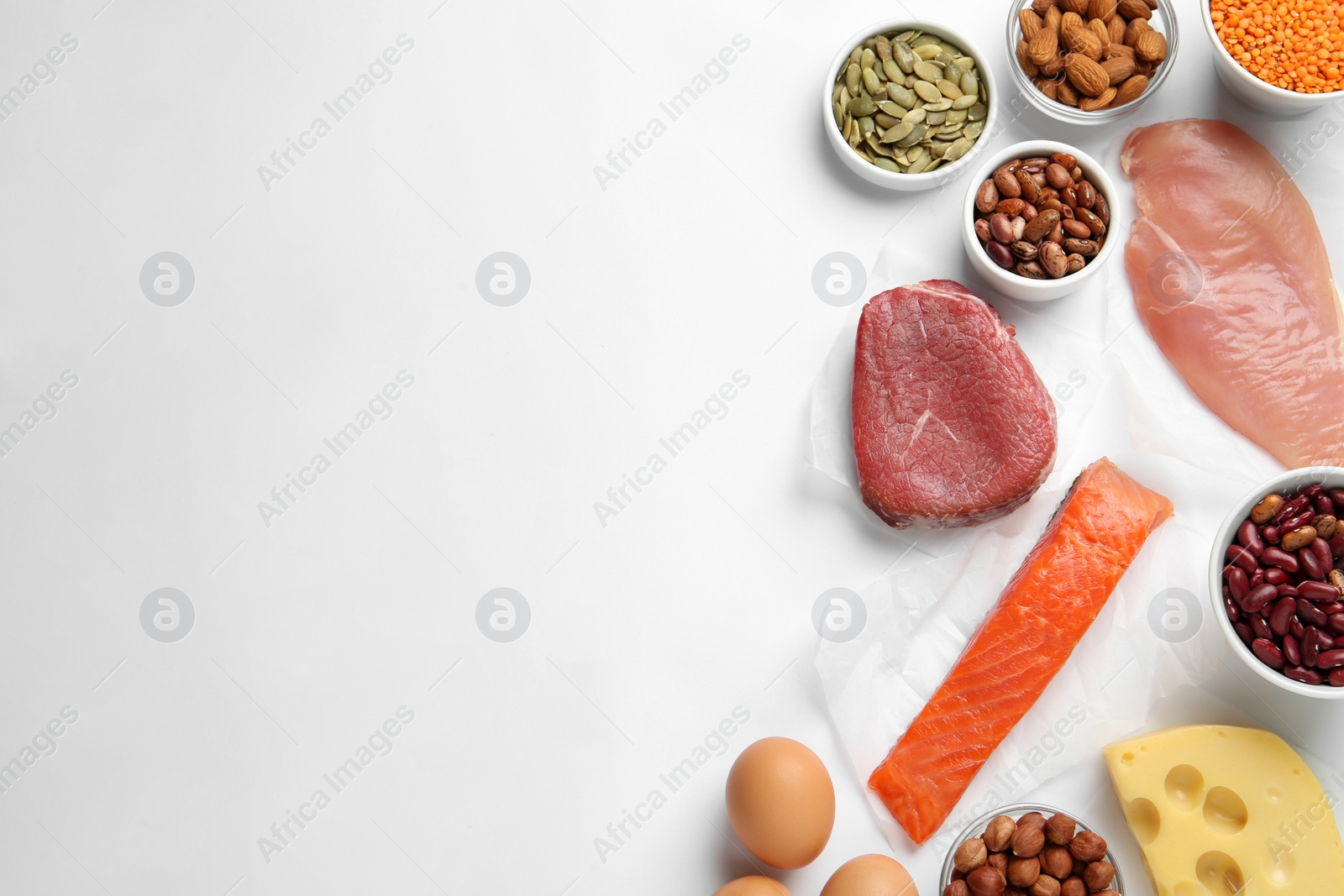 Photo of Set of products rich in amino acids on white background, flat lay. Space for text