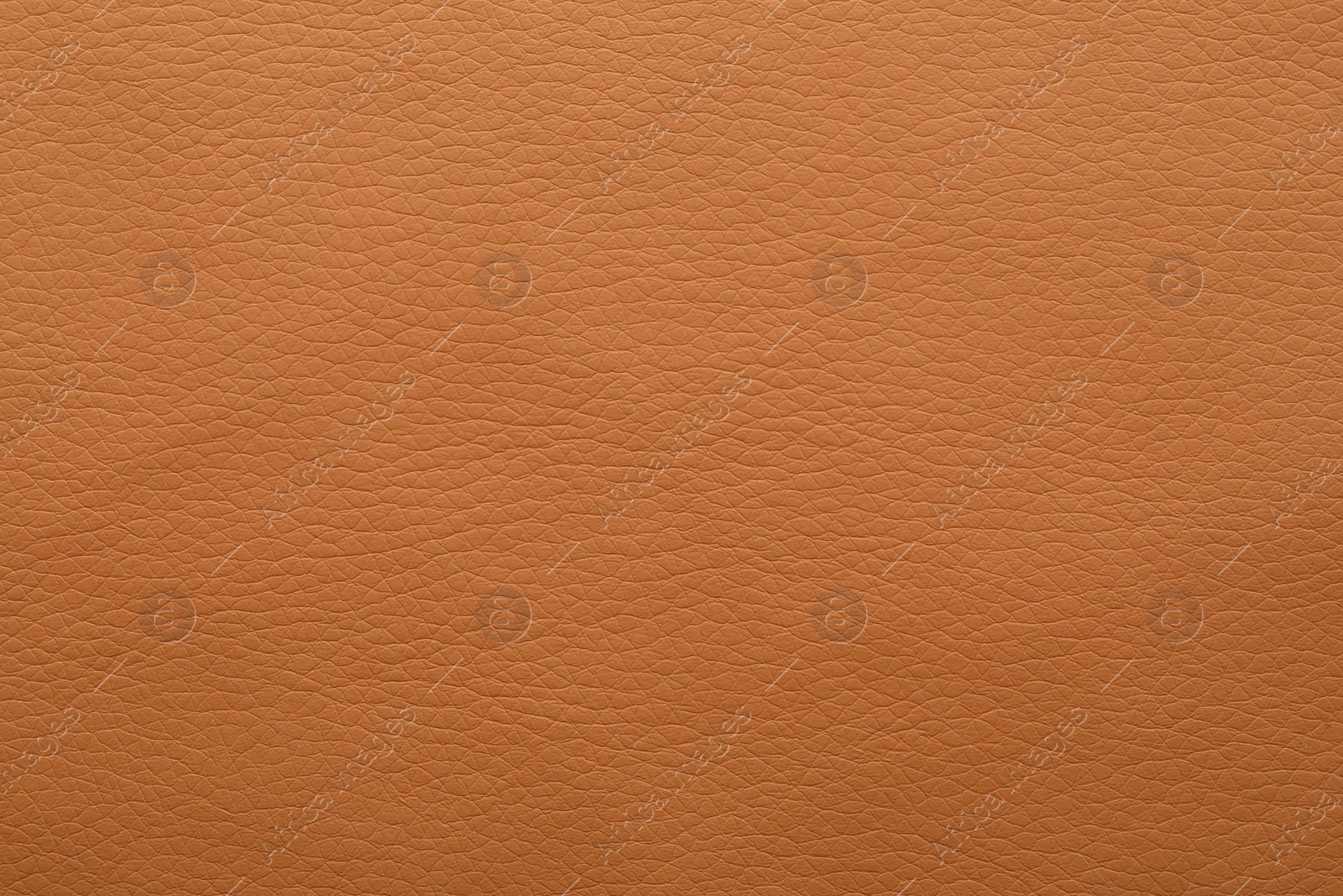 Photo of Texture of orange leather as background, closeup