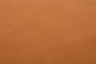 Photo of Texture of orange leather as background, closeup