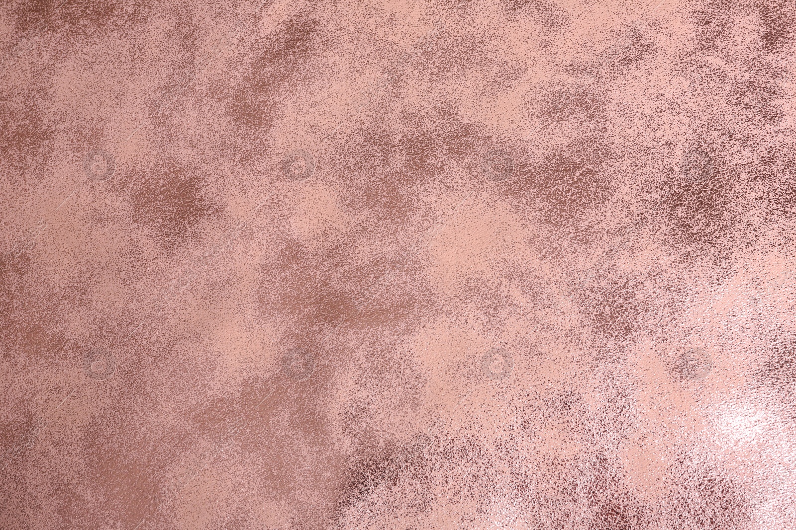 Photo of Beautiful rose gold surface as background, top view