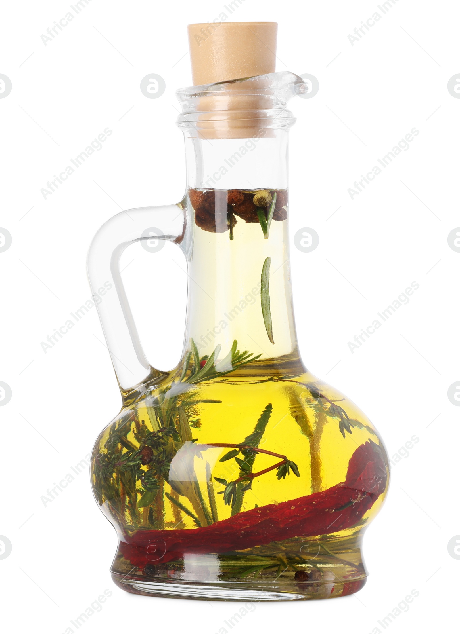 Photo of Glass jug of cooking oil with spices and herbs isolated on white