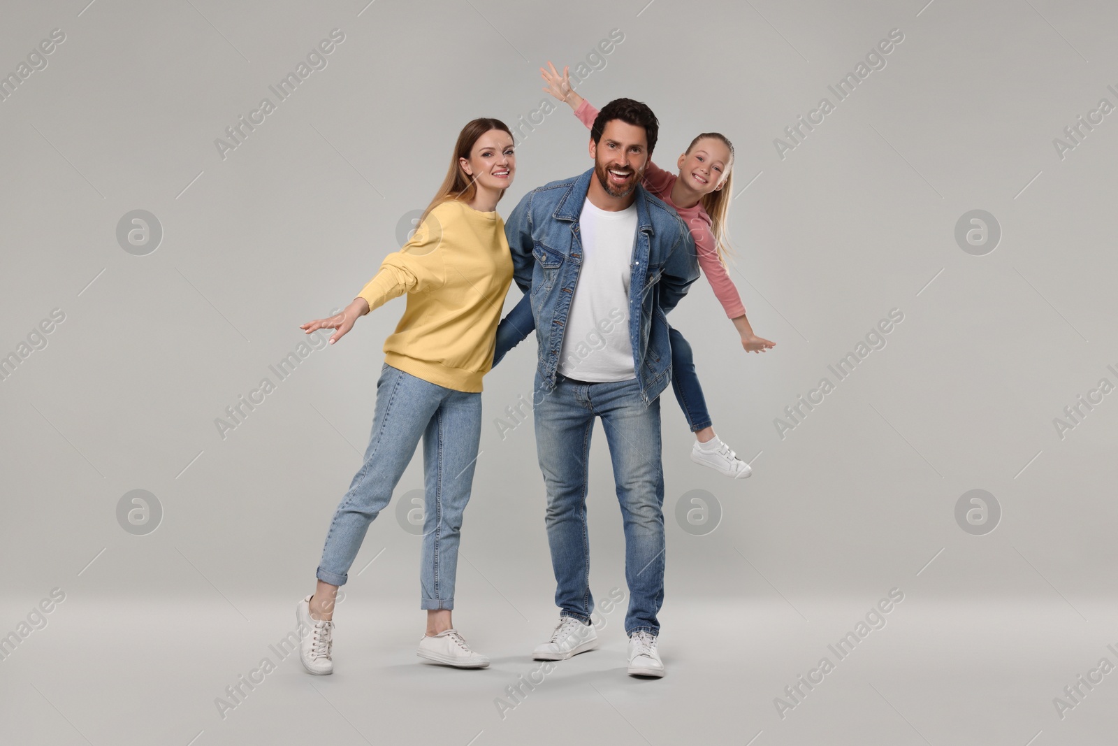 Photo of Portrait of happy family on light grey background