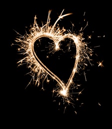 Image of Bright sparkling heart contour on black background 