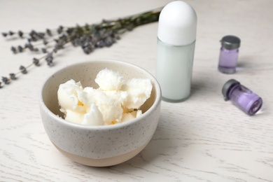Photo of Natural homemade deodorant and ingredients on wooden table