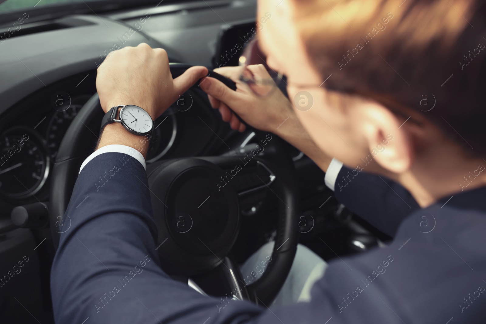 Photo of Man checking time in car, closeup. Being late