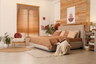 Photo of Comfortable bed with stylish linens. Interior design