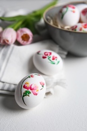 Photo of Beautifully painted Easter eggs on white table