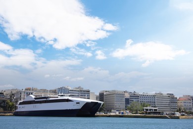 Modern ferry in sea port on sunny day