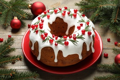 Photo of Composition with traditional Christmas cake and decorations on wooden table