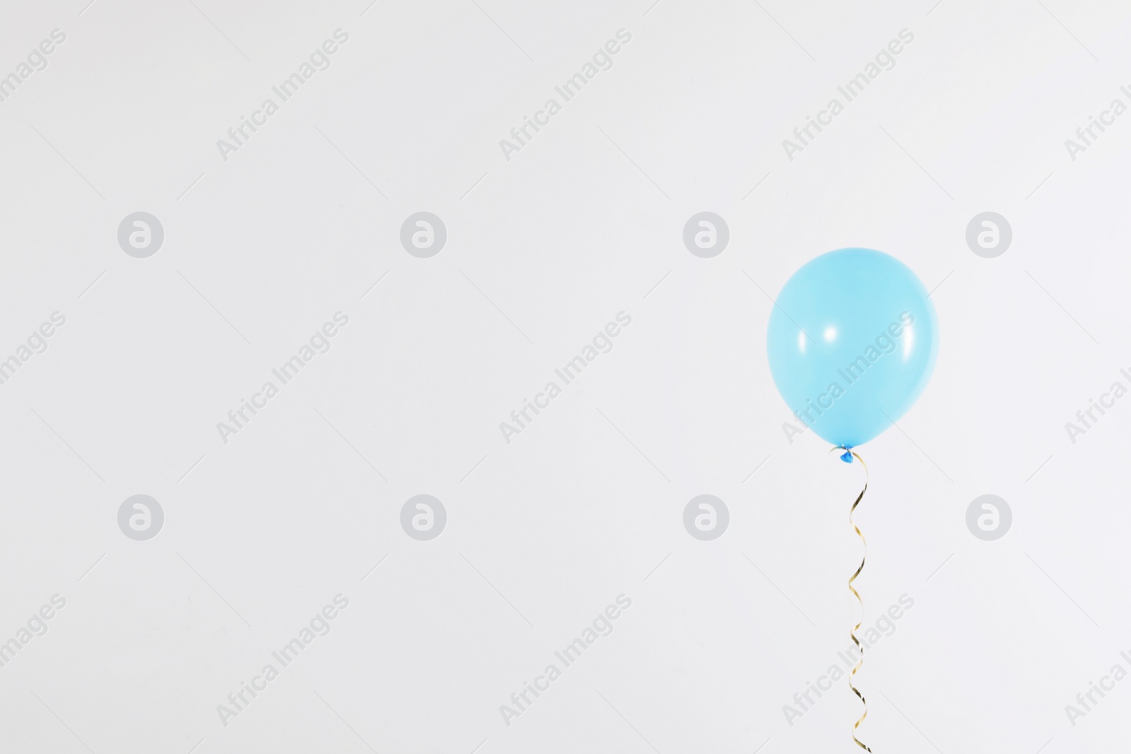 Photo of Bright balloon on light background, space for text. Celebration time