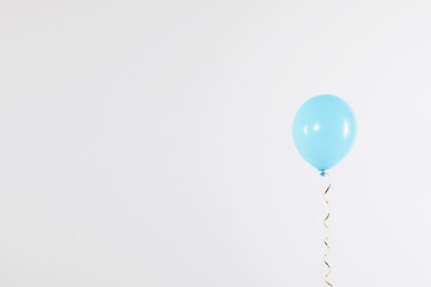 Photo of Bright balloon on light background, space for text. Celebration time