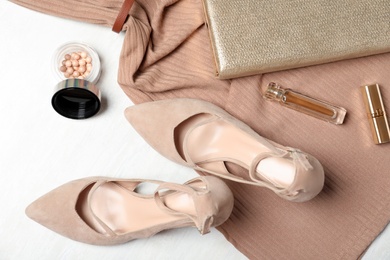 Photo of Flat lay composition with beige lady's shoes on white wooden table