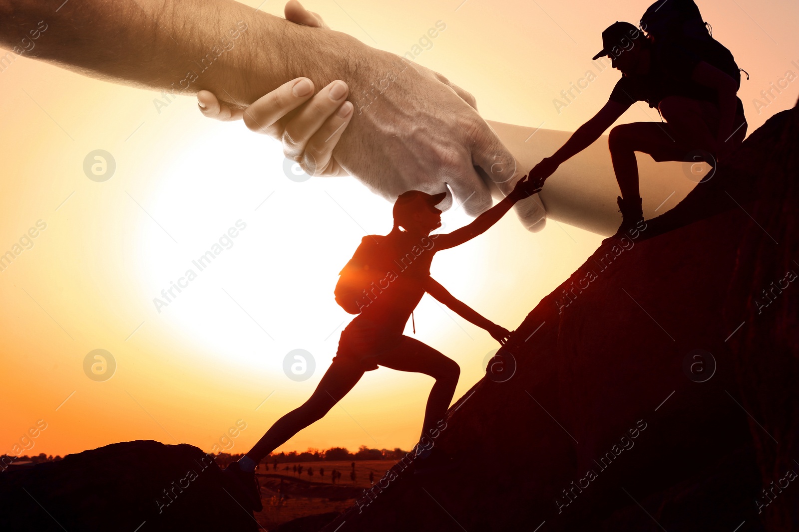 Image of Double exposure of people climbing up mountain and helping hand