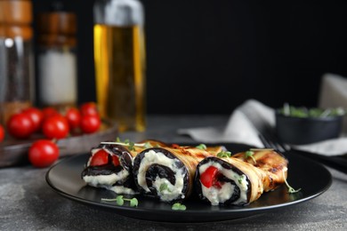 Delicious baked eggplant rolls served on grey table, space for text