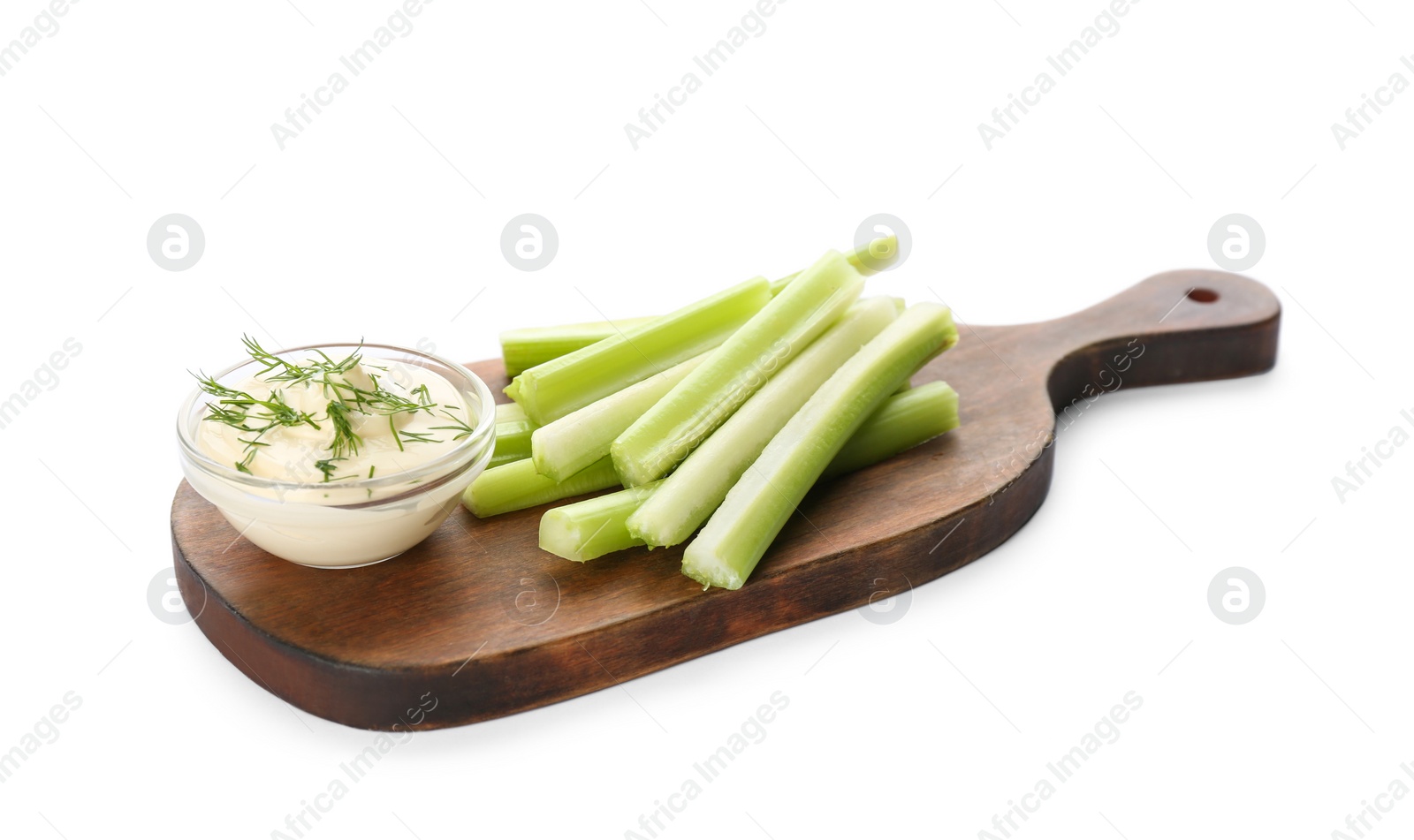 Photo of Wooden board with dip sauce and celery sticks isolated on white