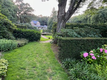 Photo of Netherlands, Amsterdam - July 19, 2022: Luxury hotel Het Roode Koper in beautiful green forest