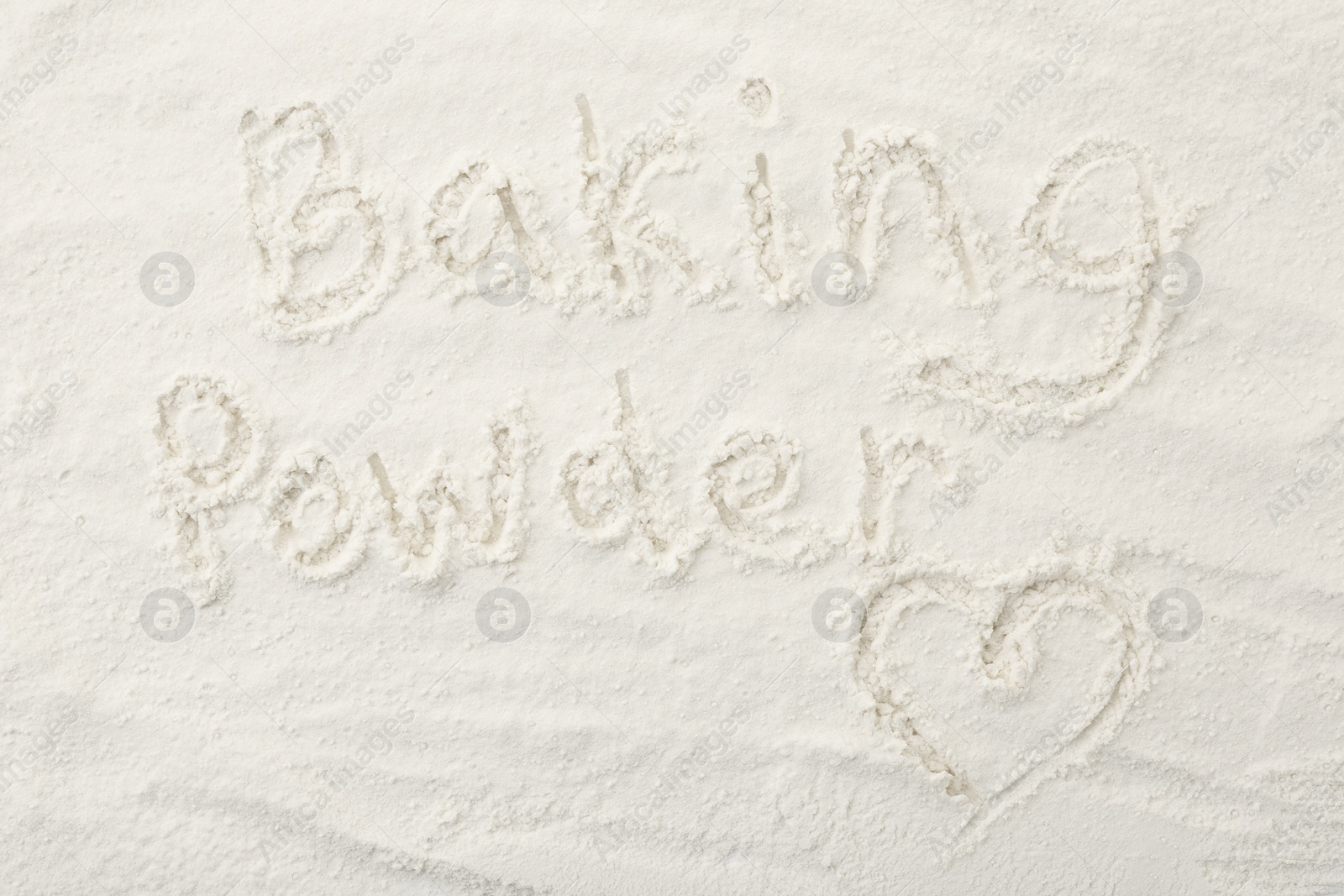 Photo of Words Baking Powder and heart written on powder, top view