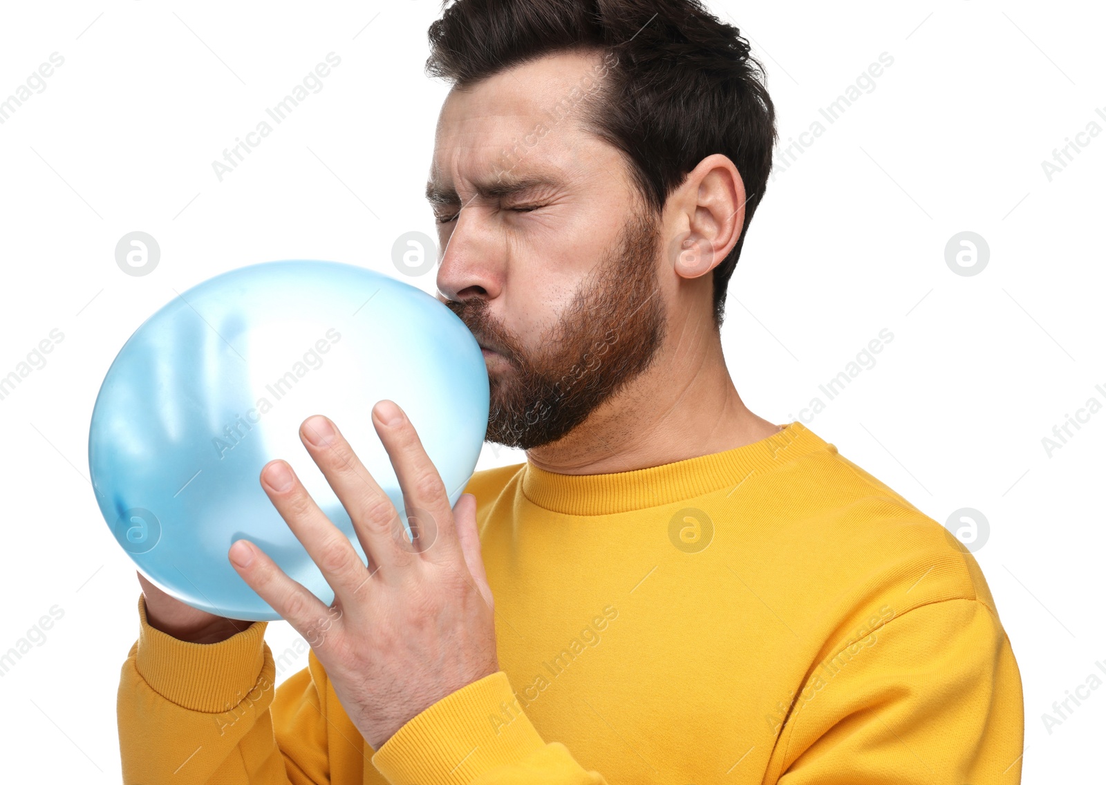 Photo of Man inflating light blue balloon on white background