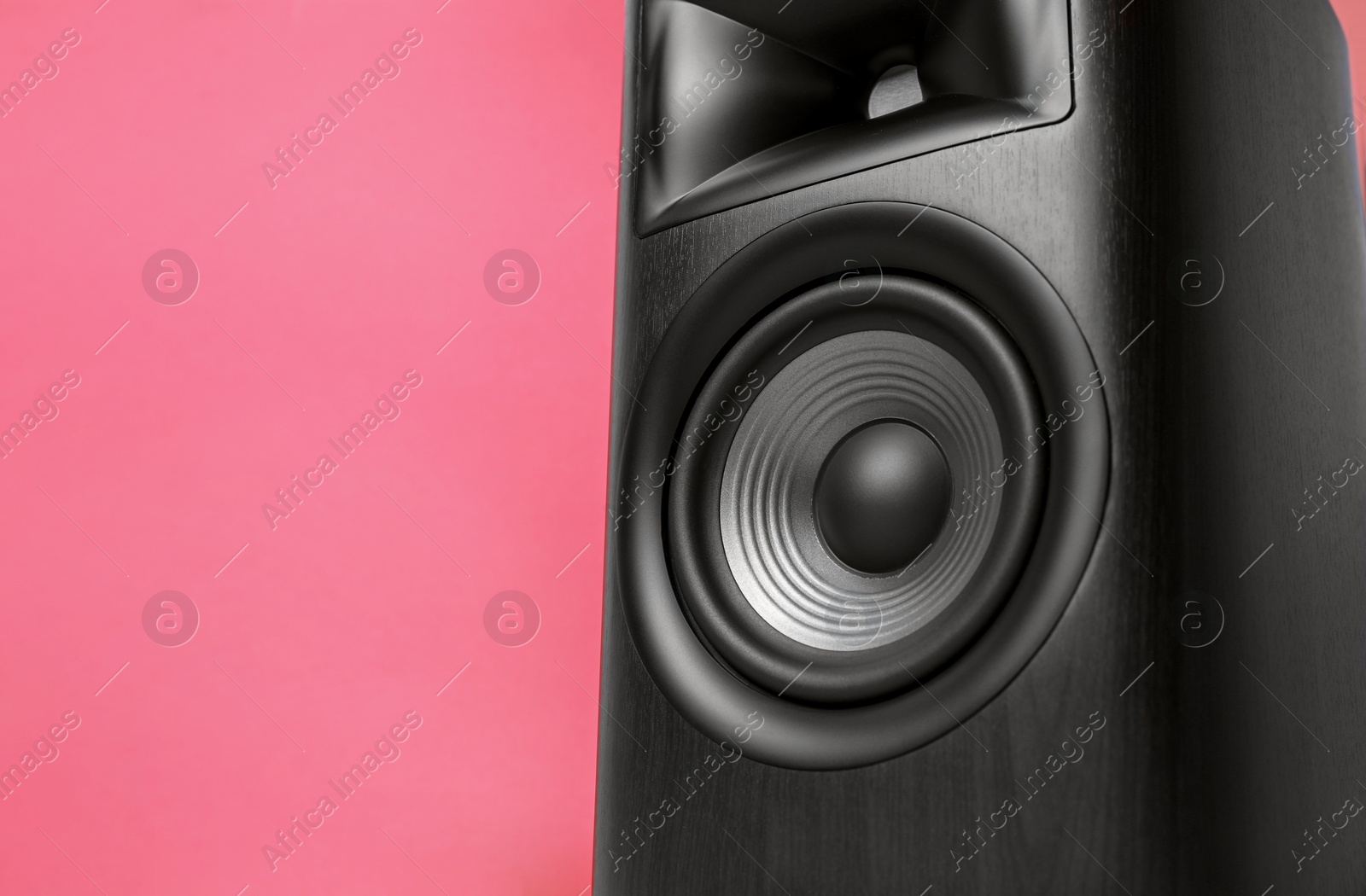 Photo of One wooden sound speaker on red background, closeup. Space for text