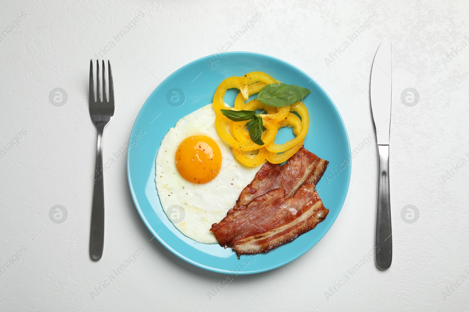 Photo of Tasty breakfast with fried egg served on light table, flat lay