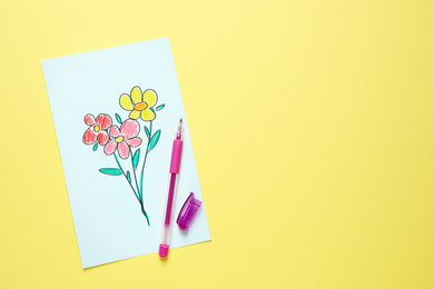 Photo of Top view of greeting card with drawn flowers and pen on yellow background, space for text. Happy Mother's day