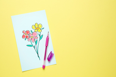 Top view of greeting card with drawn flowers and pen on yellow background, space for text. Happy Mother's day