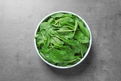 Photo of Fresh green healthy spinach on grey table, top view